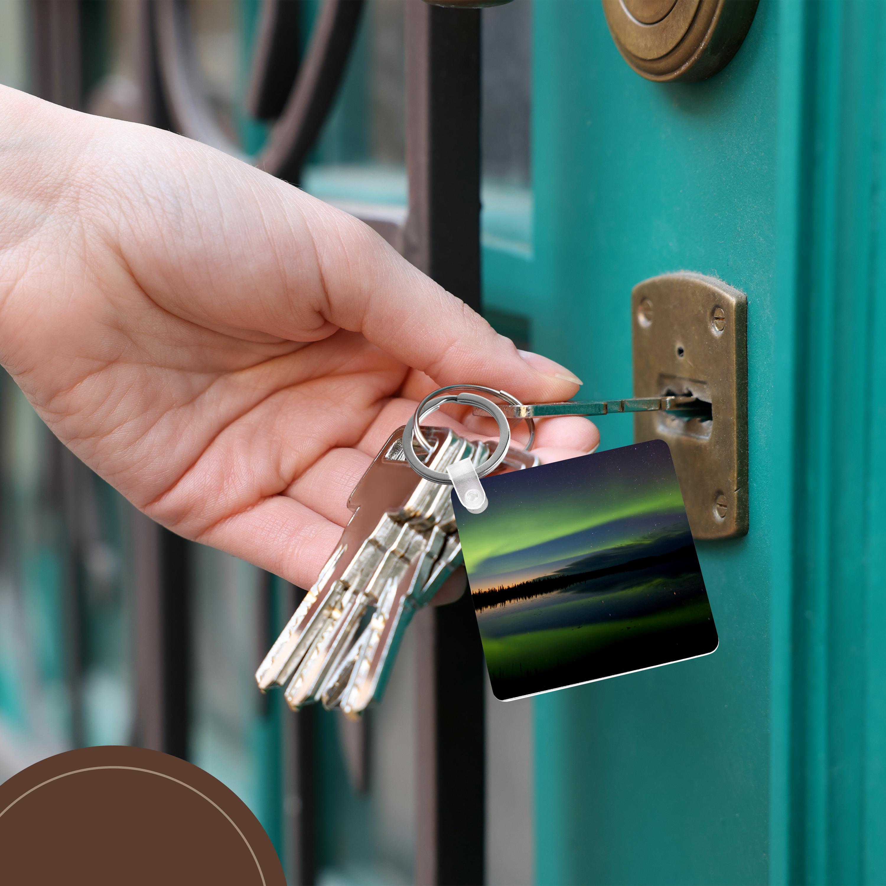 Key Chain - USA, Alaska, Bettles. Aurora borealis reflects in Vor Lake Waterlane. Northern Lights